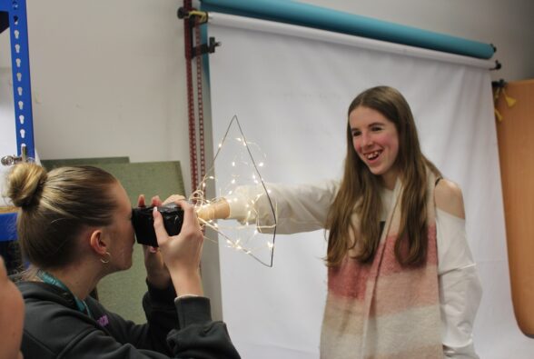 Photography student Emily Voyce taking a Bokeh style picture of Photography student Daisy Spiers