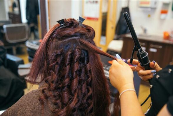 A lady having her hair curled
